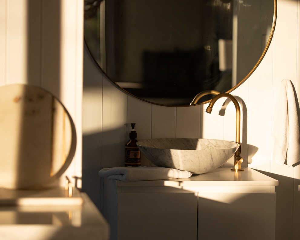 Bathroom detail with gold tap and marble basin