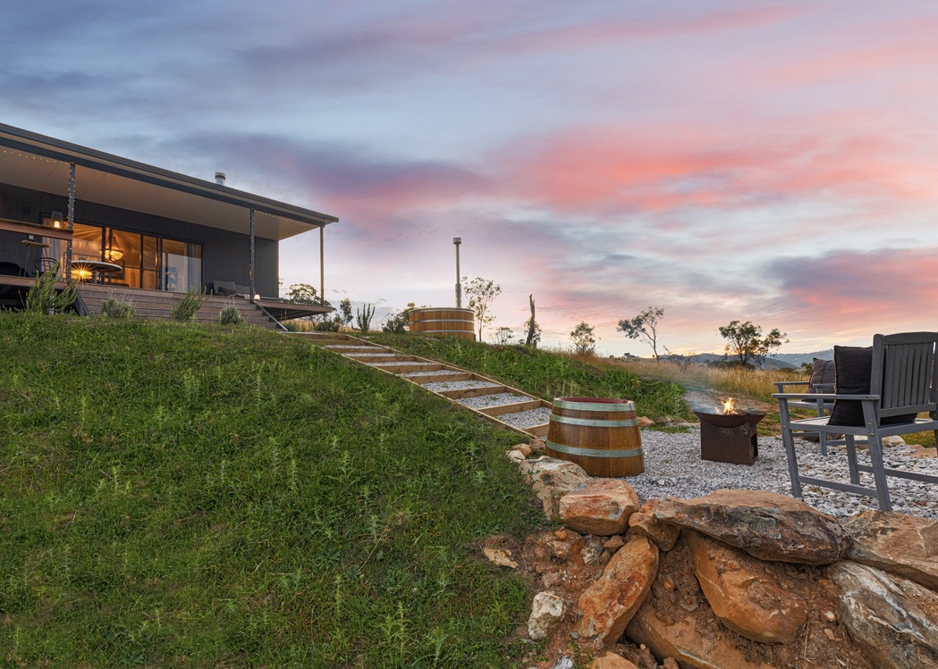 SIPs cabin at pink sunset with fire pit