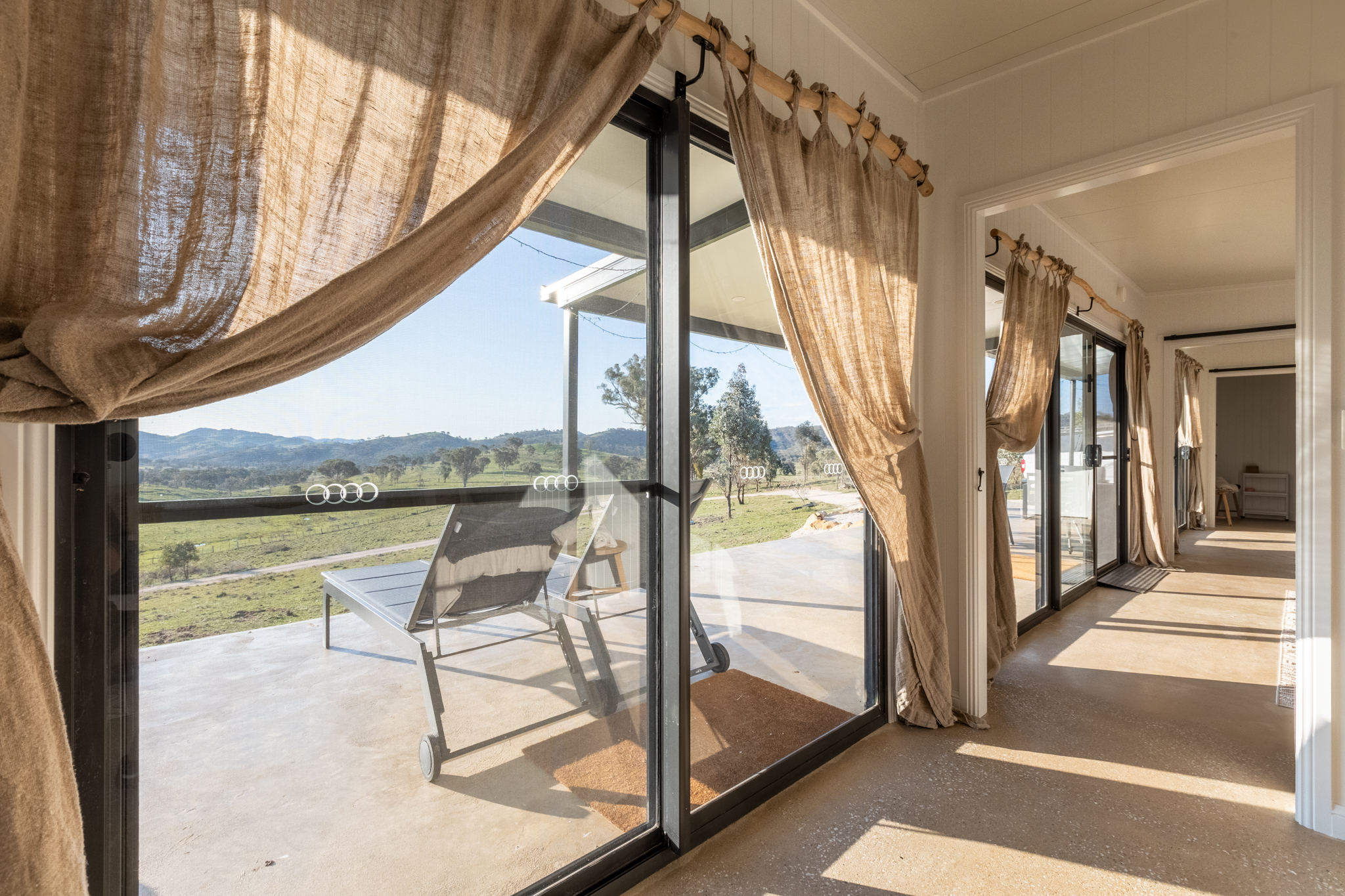 SIPs interior with hessian curtains and deck view