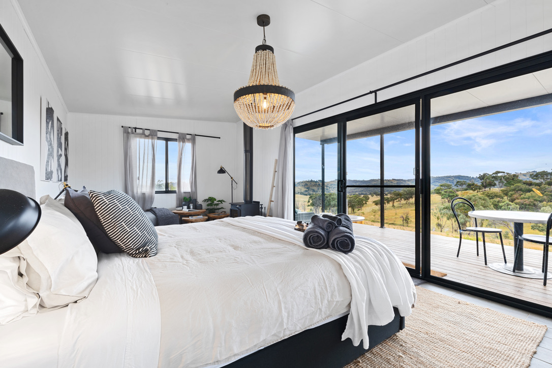 Bright cabin bedroom with bead chandelier