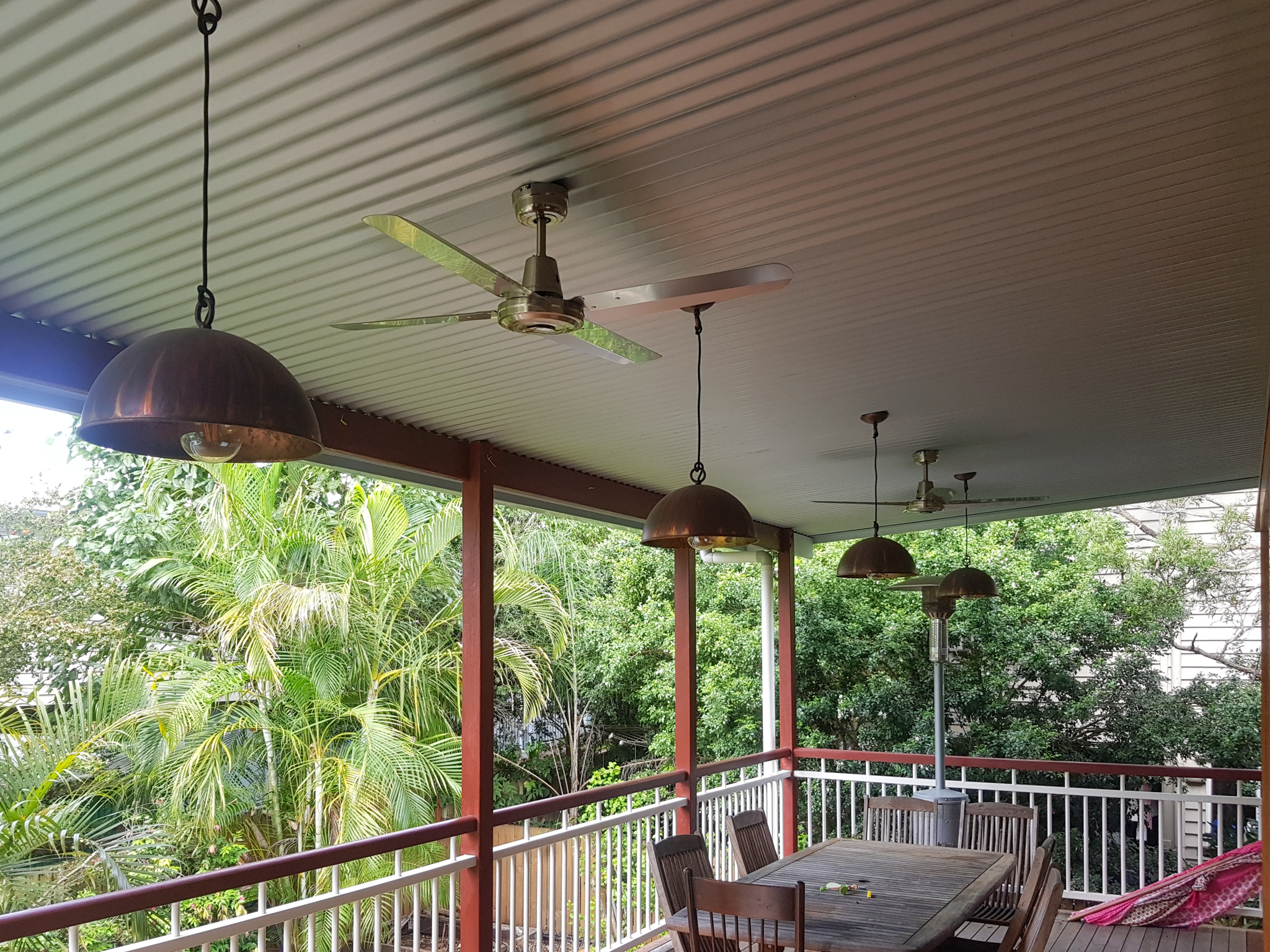 Alfresco patio with corrugated ceiling and copper pendant lights